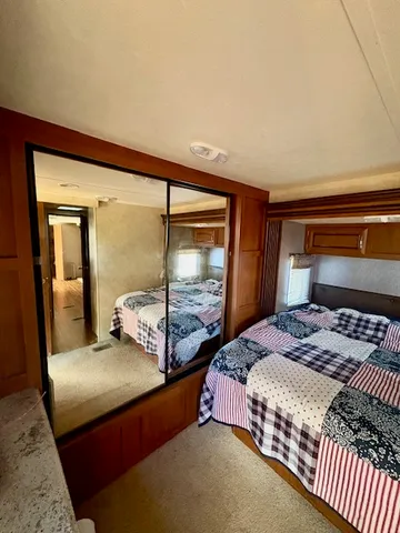 a bedroom with a large bed and two large window