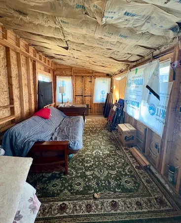 a bed sitting in a bedroom next to a window