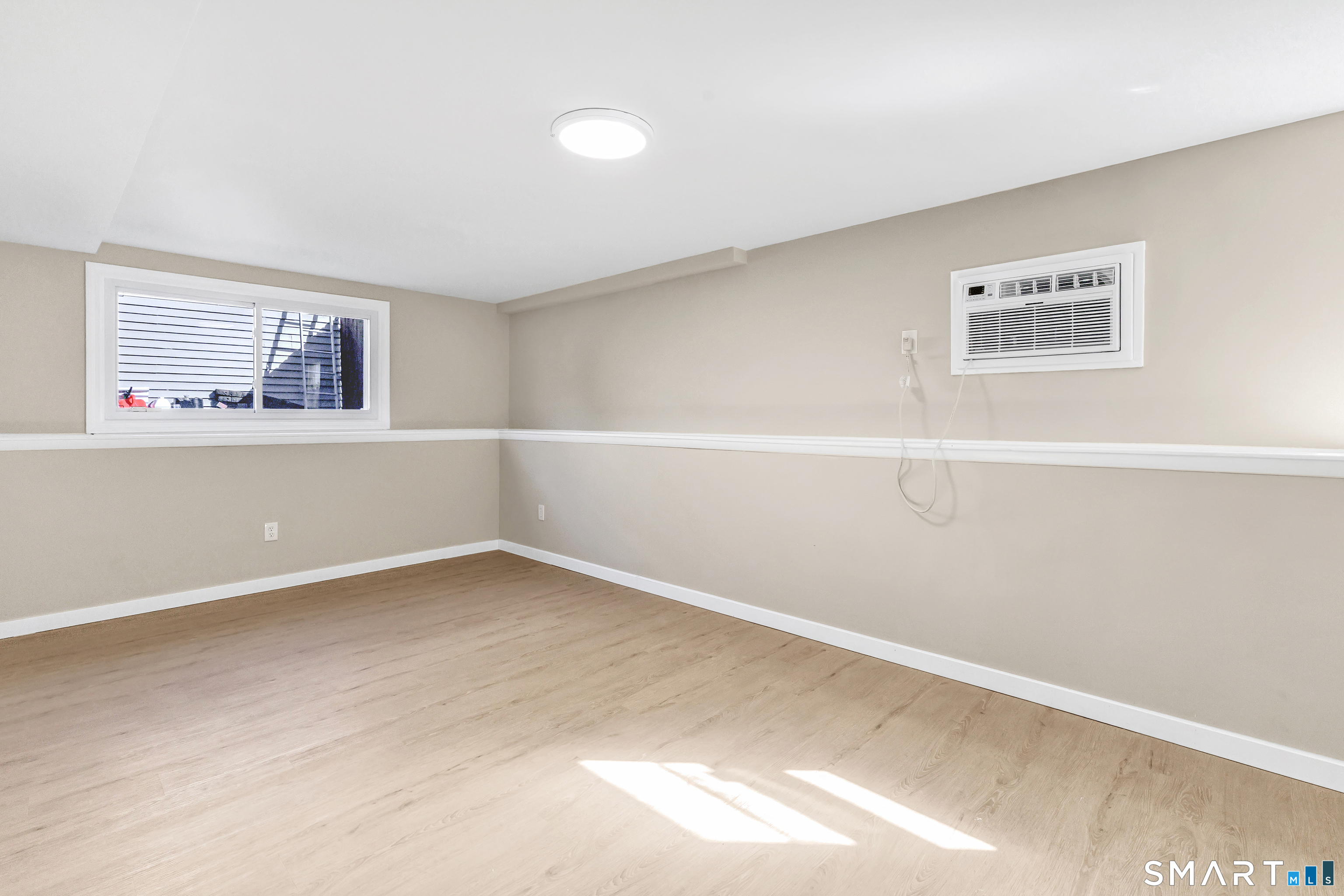 77 Meadow Lark Road Naugatuck, CT 06770 - Photo 25 of 40 Lower level - Finished bedroom, code compliant egress window, vinyl floor, custom built closet with doors, wall unit for cooling