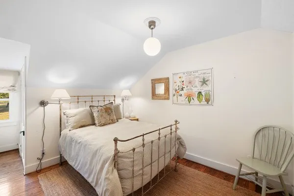 a bedroom with a bed and a chair