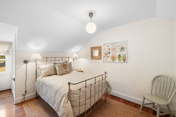 6020 Valley View Lane Brenham, TX 77833 - Photo 15 of 29 a bedroom with a bed and wooden floor