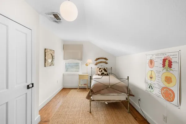 a bedroom with two beds and a window