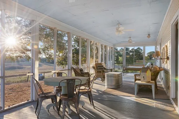 a view of backyard of house with wooden fence