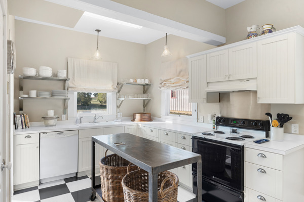 6020 Valley View Lane Brenham, TX 77833 - Photo 10 of 29 a kitchen with a sink a stove a refrigerator and white cabinets