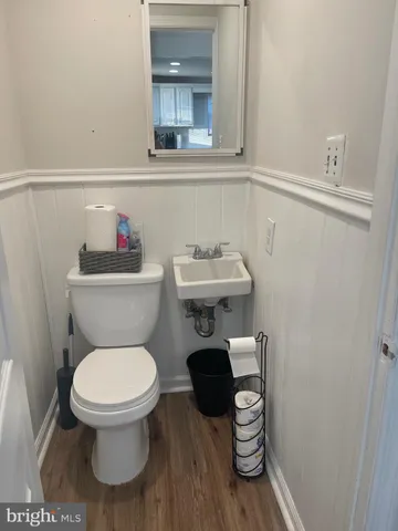 a bathroom with a toilet a sink and a window