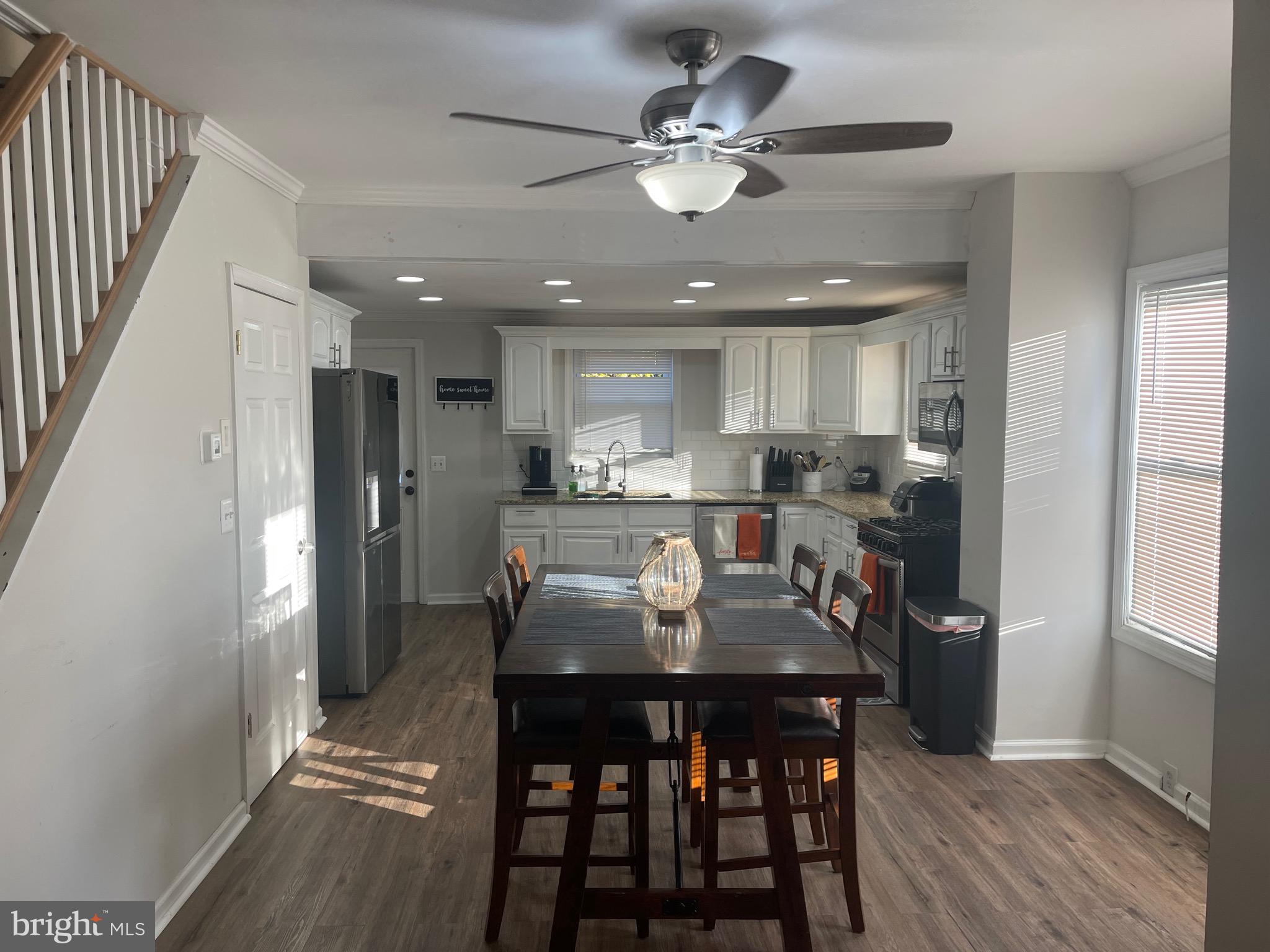 323 High Street Westville, NJ 08093 - Photo 17 of 33 a kitchen with stainless steel appliances kitchen island granite countertop a refrigerator a stove a microwave oven with a dining table and chairs