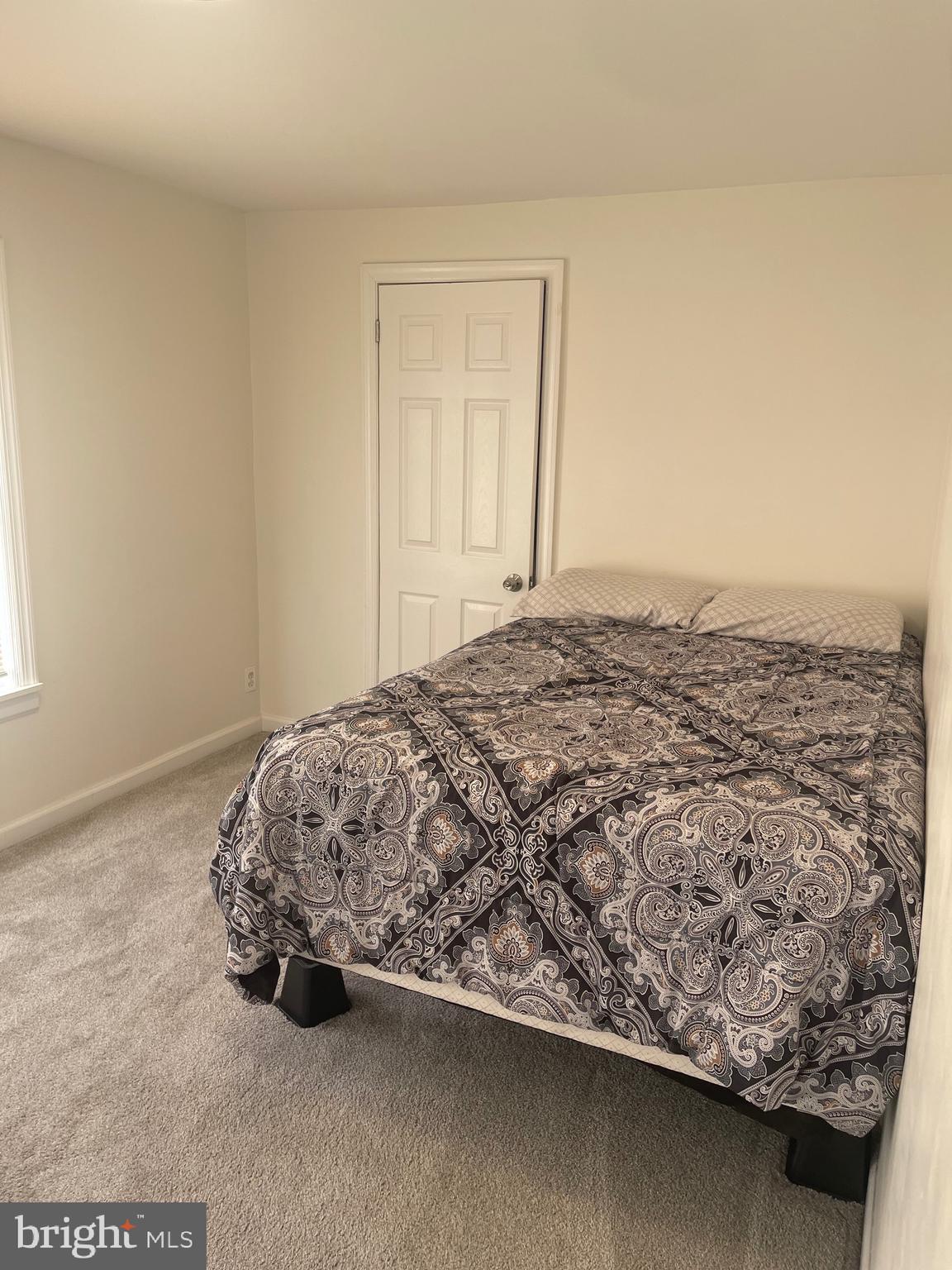 323 High Street Westville, NJ 08093 - Photo 22 of 33 a bed sitting in a bedroom next to a window