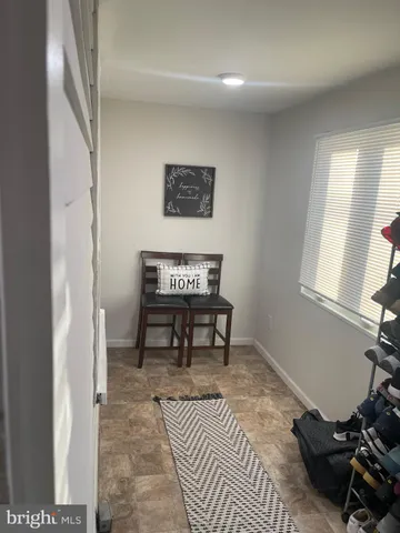 a living room with furniture a rug and a window