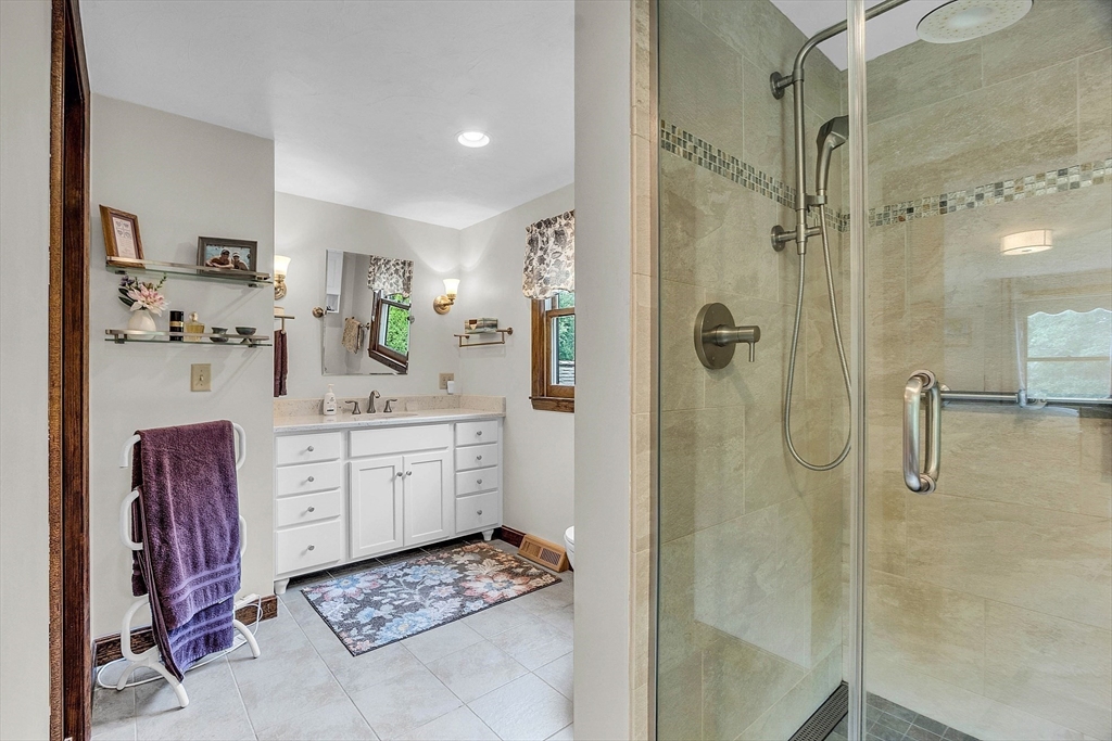 26 Wilder Road Sterling, MA 01564 - Photo 23 of 28 a bathroom with a sink vanity granite tub shower and mirror