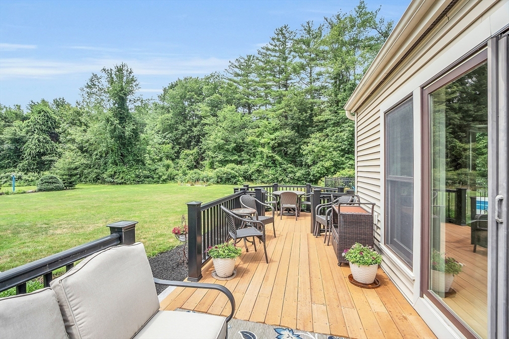 26 Wilder Road Sterling, MA 01564 - Photo 8 of 28 a view of a patio with lawn chairs next to a yard
