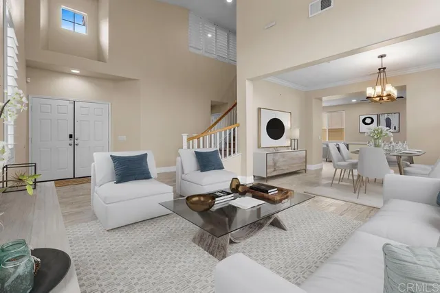 a living room with furniture and a chandelier