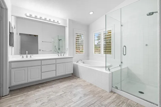 a bathroom with a tub sink and mirror