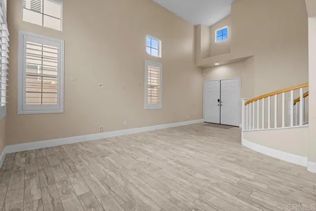 a view of a livingroom with wooden floor and chandelier