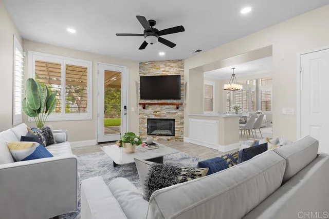 a living room with furniture a fireplace and a flat screen tv