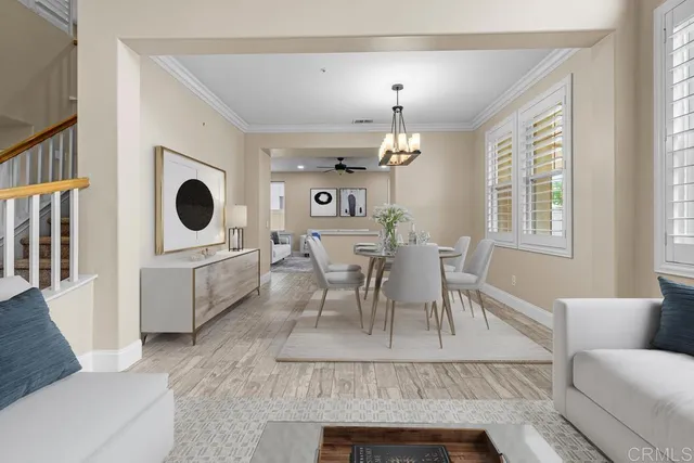 a living room with furniture a dining table and a fireplace