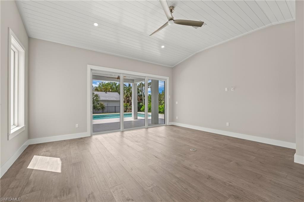 1134 Trail Terrace Drive Naples, FL 34103 - Photo 12 of 37 Spare room with wood ceiling, baseboards, ceiling fan, and wood finished floors