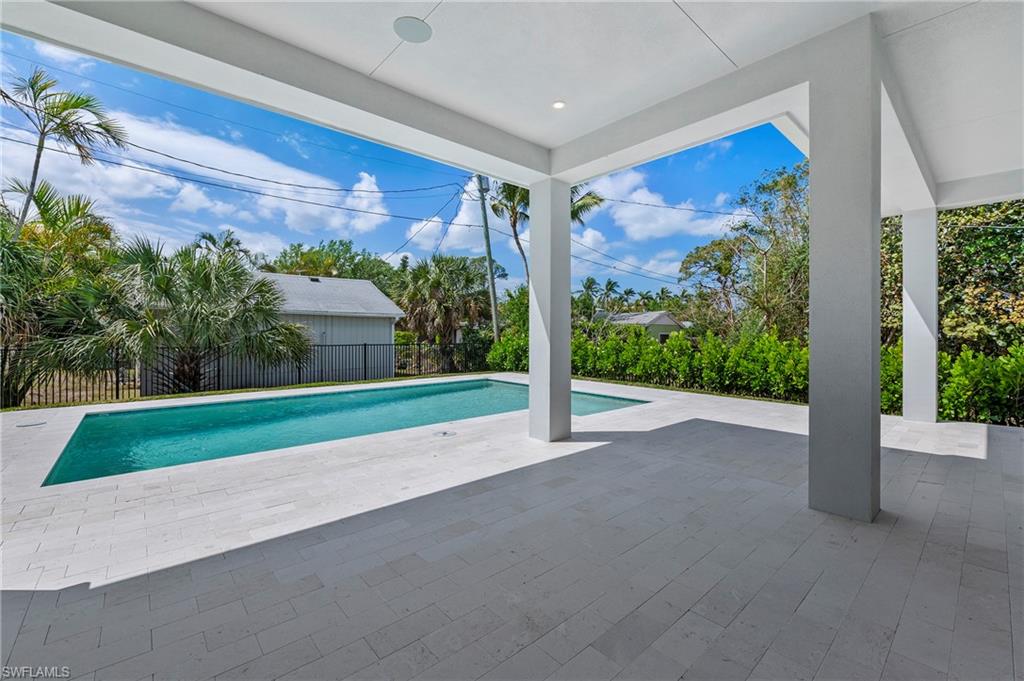 1134 Trail Terrace Drive Naples, FL 34103 - Photo 16 of 37 View of swimming pool featuring a fenced in pool, fence, and a patio