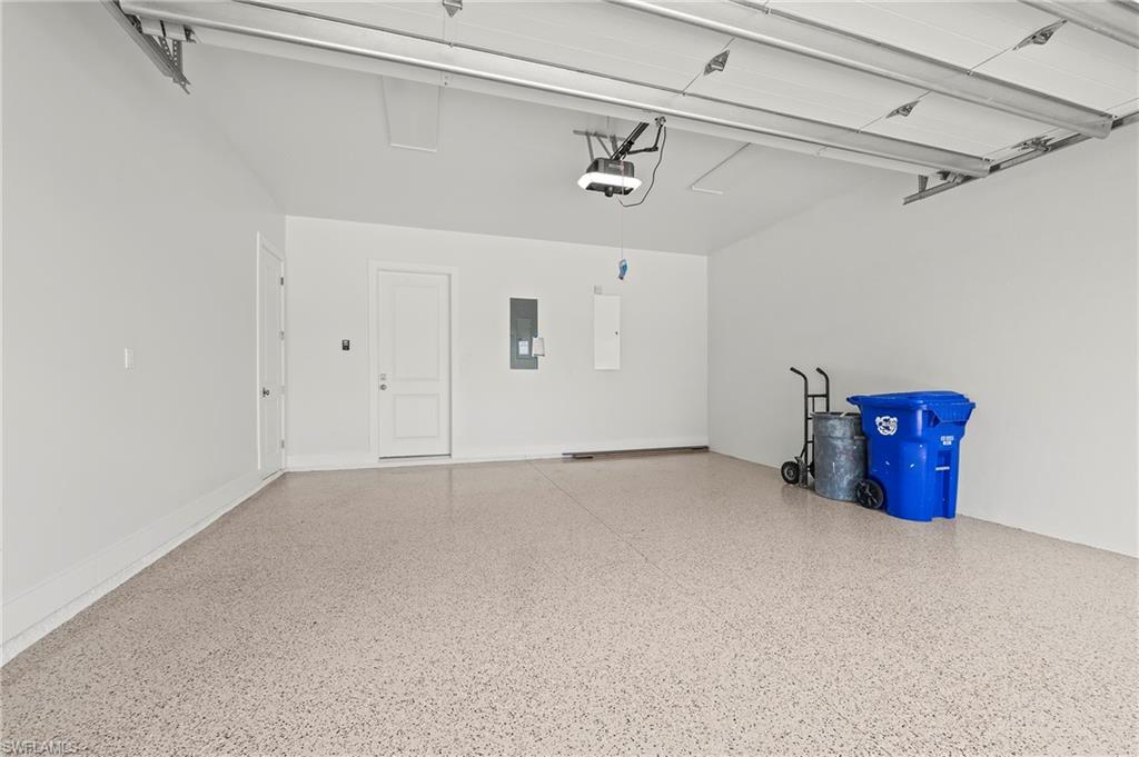 1134 Trail Terrace Drive Naples, FL 34103 - Photo 35 of 37 Garage with electric panel and a garage door opener