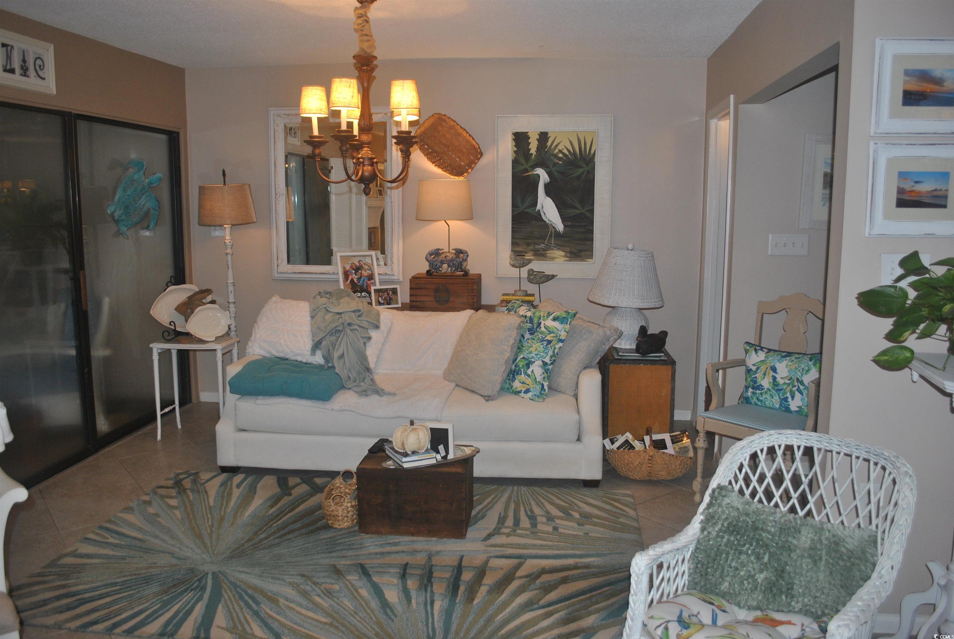 30 Little Point Road, Unit 33 Georgetown, SC 29440 - Photo 3 of 27 Tiled living room with a chandelier