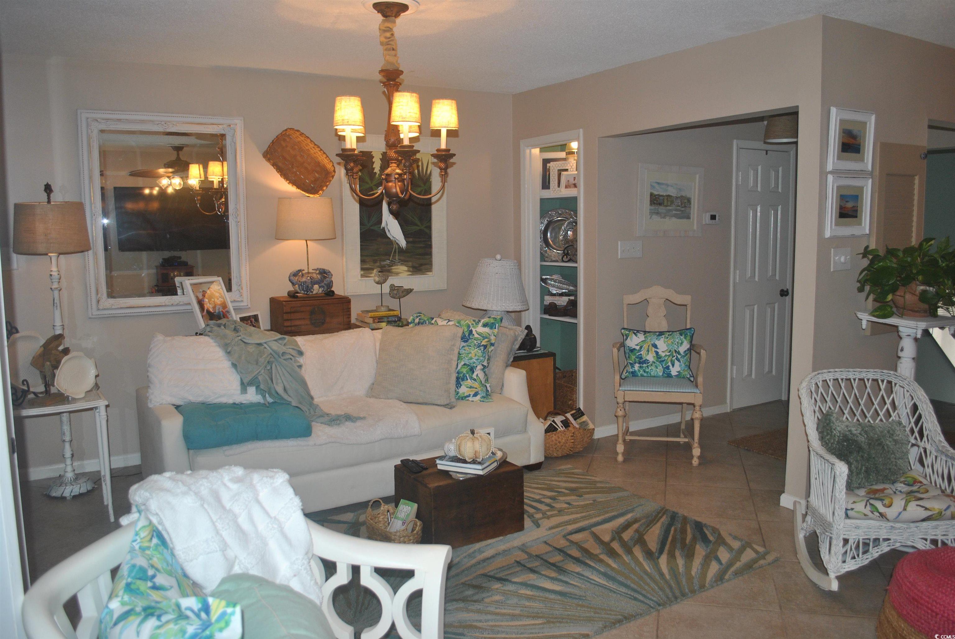 30 Little Point Road, Unit 33 Georgetown, SC 29440 - Photo 4 of 27 Living room featuring a chandelier and tile patter