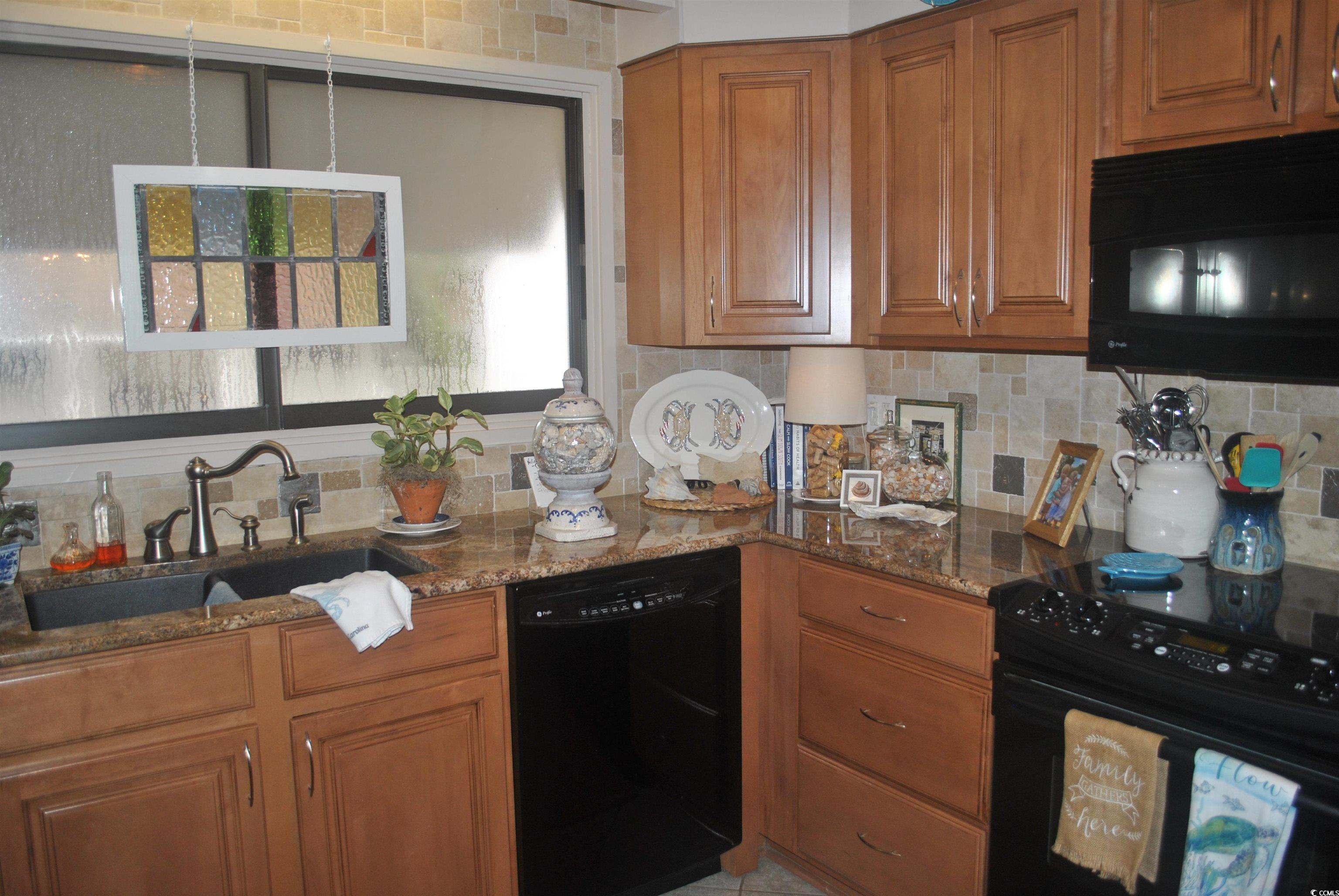 30 Little Point Road, Unit 33 Georgetown, SC 29440 - Photo 7 of 27 Kitchen with black appliances, sink, tasteful back