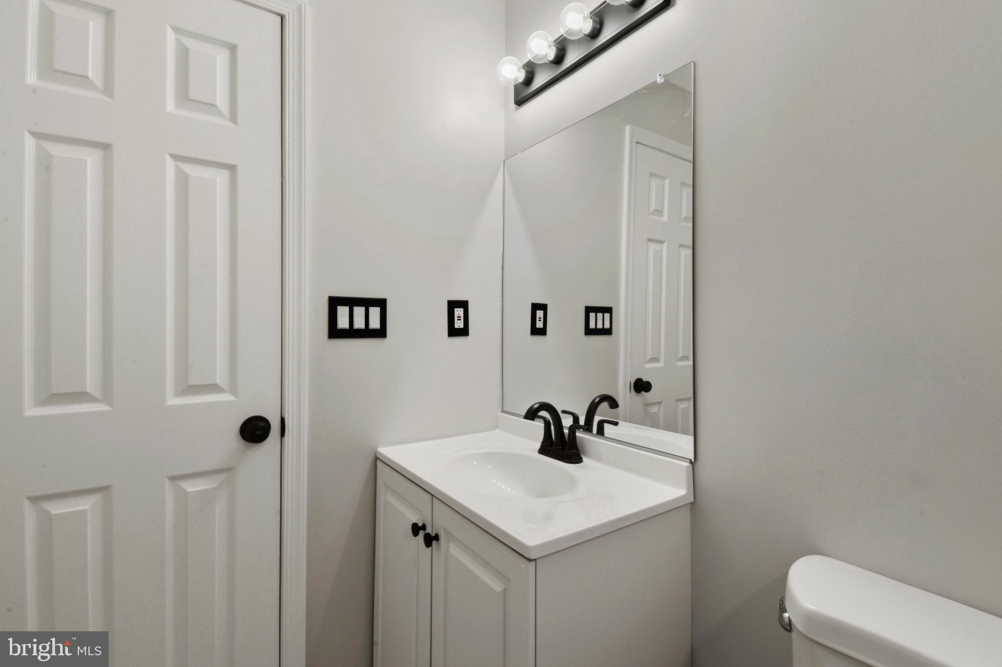 620 B Street Staunton, VA 24401 - Photo 13 of 26 a bathroom with a sink a toilet and mirror