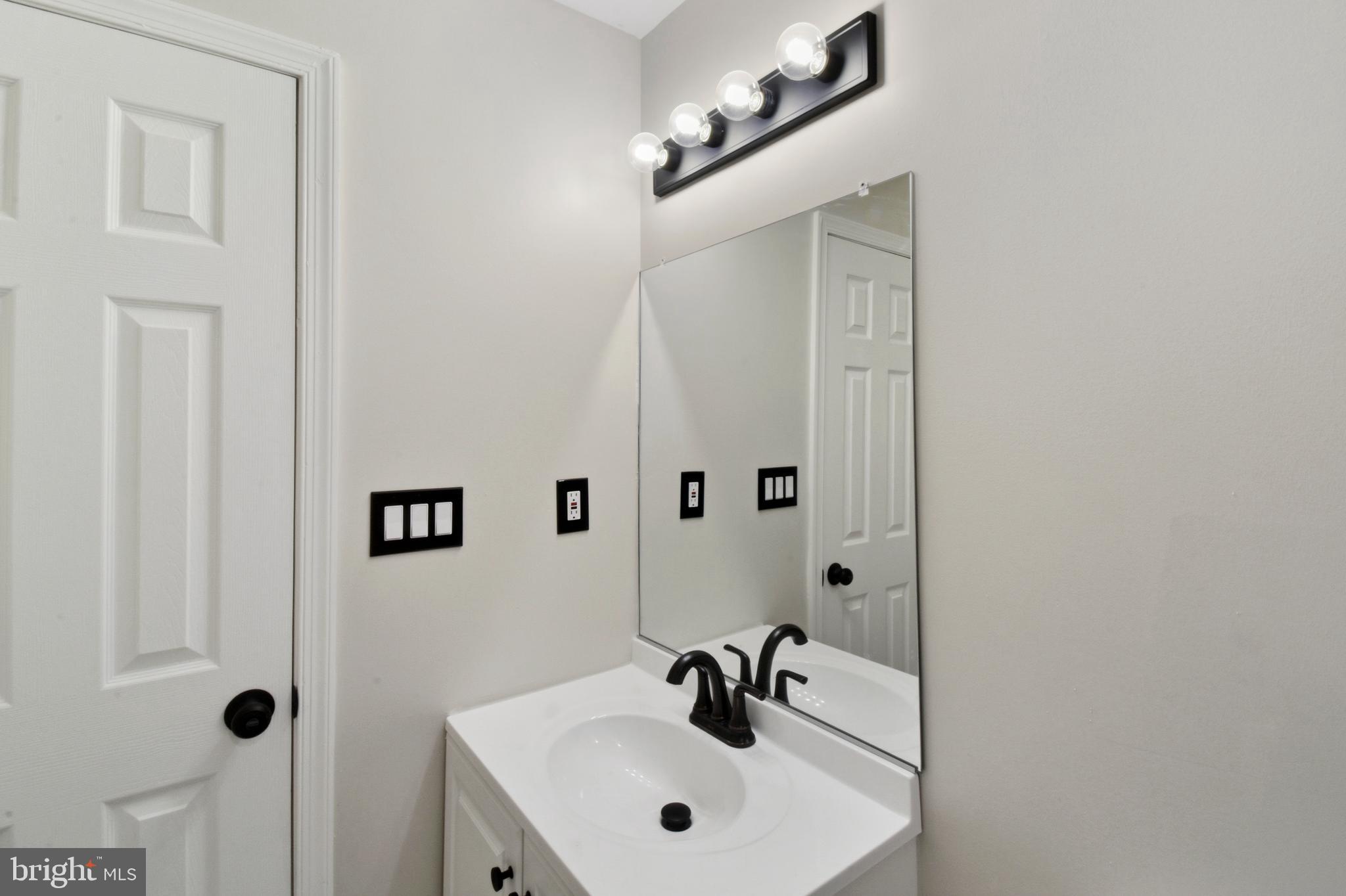 620 B Street Staunton, VA 24401 - Photo 14 of 26 a bathroom with a sink a mirror and shower