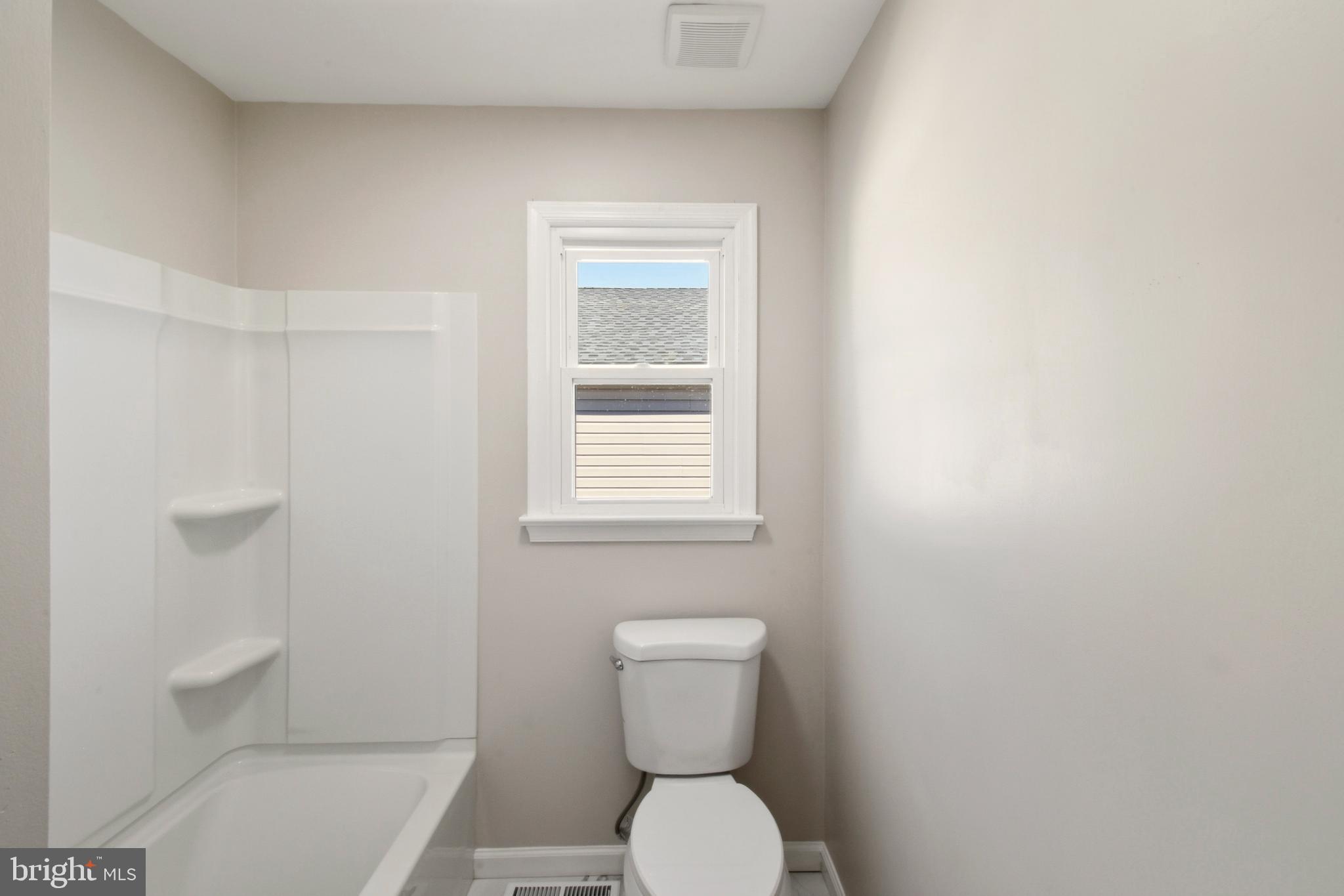 620 B Street Staunton, VA 24401 - Photo 16 of 26 a white toilet sitting next to a bathroom sink and vanity