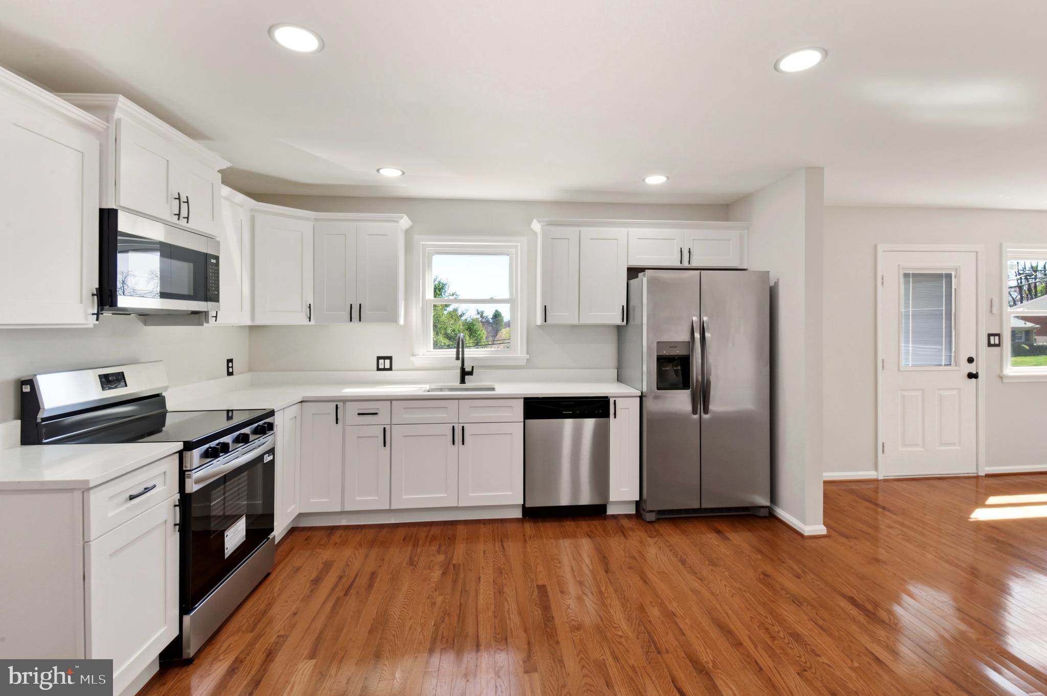 620 B Street Staunton, VA 24401 - Photo 3 of 26 a kitchen with a refrigerator a stove top oven a sink dishwasher and wooden floor