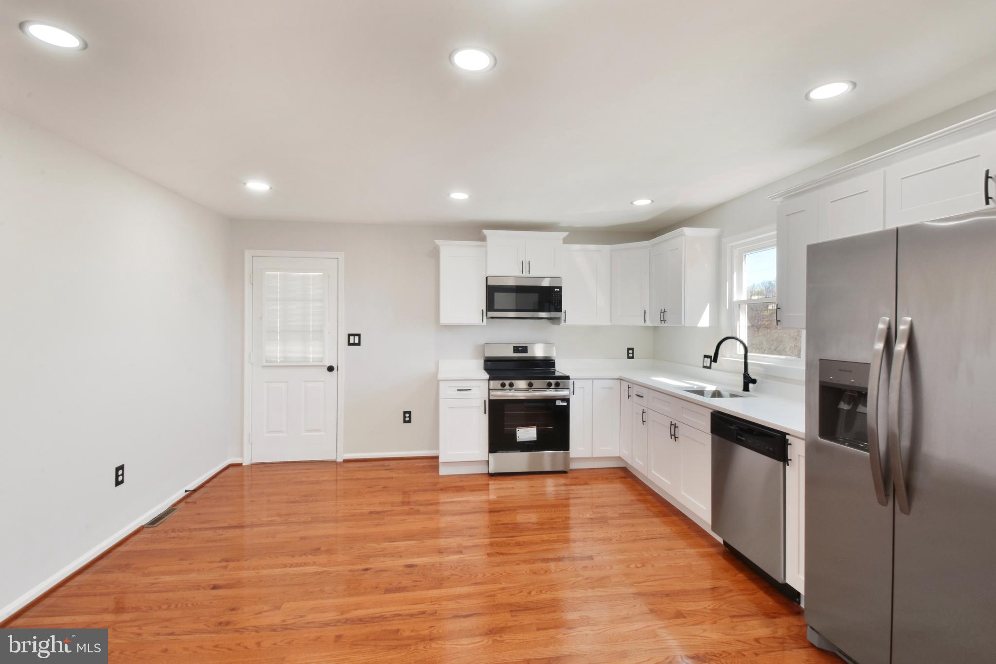 620 B Street Staunton, VA 24401 - Photo 4 of 26 a large kitchen with stainless steel appliances granite countertop a stove a sink and a refrigerator