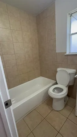 a bathroom with a toilet and a bathtub