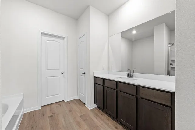 a bathroom with a double vanity sink and mirror