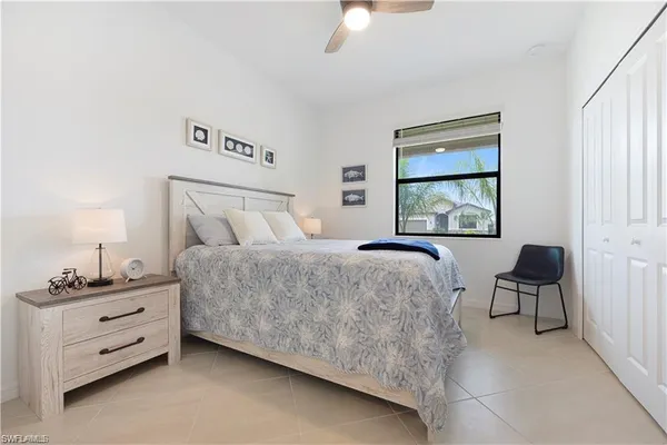 a bedroom with a bed and painting on the wall