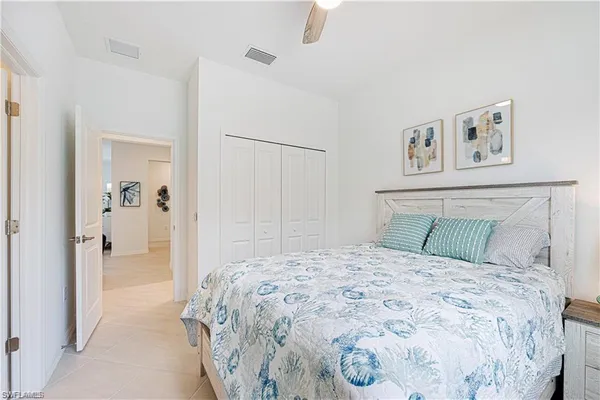 a bedroom with a bed chair and window