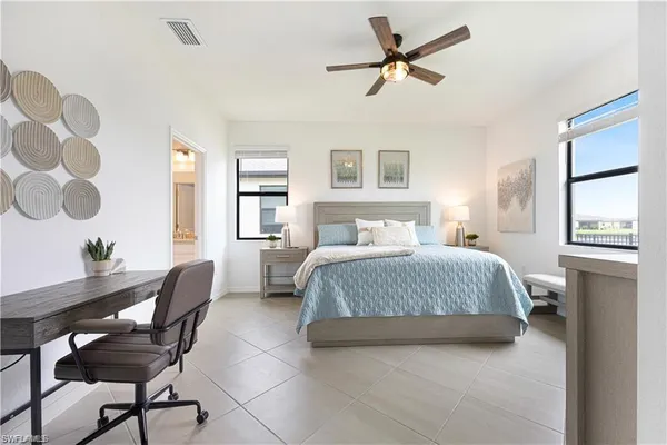 a bedroom with a bed and ceiling fan