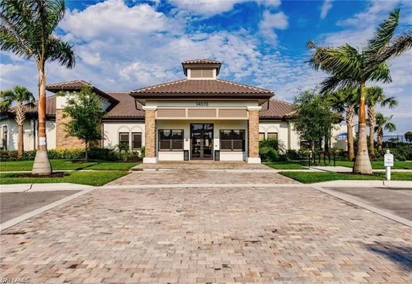 an aerial view of a house with a garden and lake view