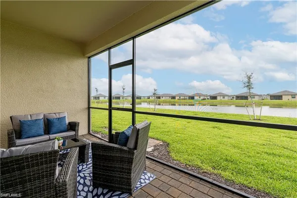 a living room with furniture and floor to ceiling windows