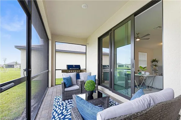 a view of a kitchen with refrigerator and white cabinets