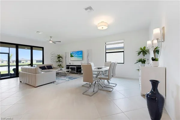 a view of a dining room with furniture and a potted plant