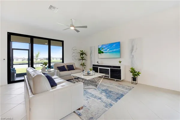 a kitchen with stainless steel appliances granite countertop a refrigerator a stove sink a microwave oven with white cabinets and wooden floor