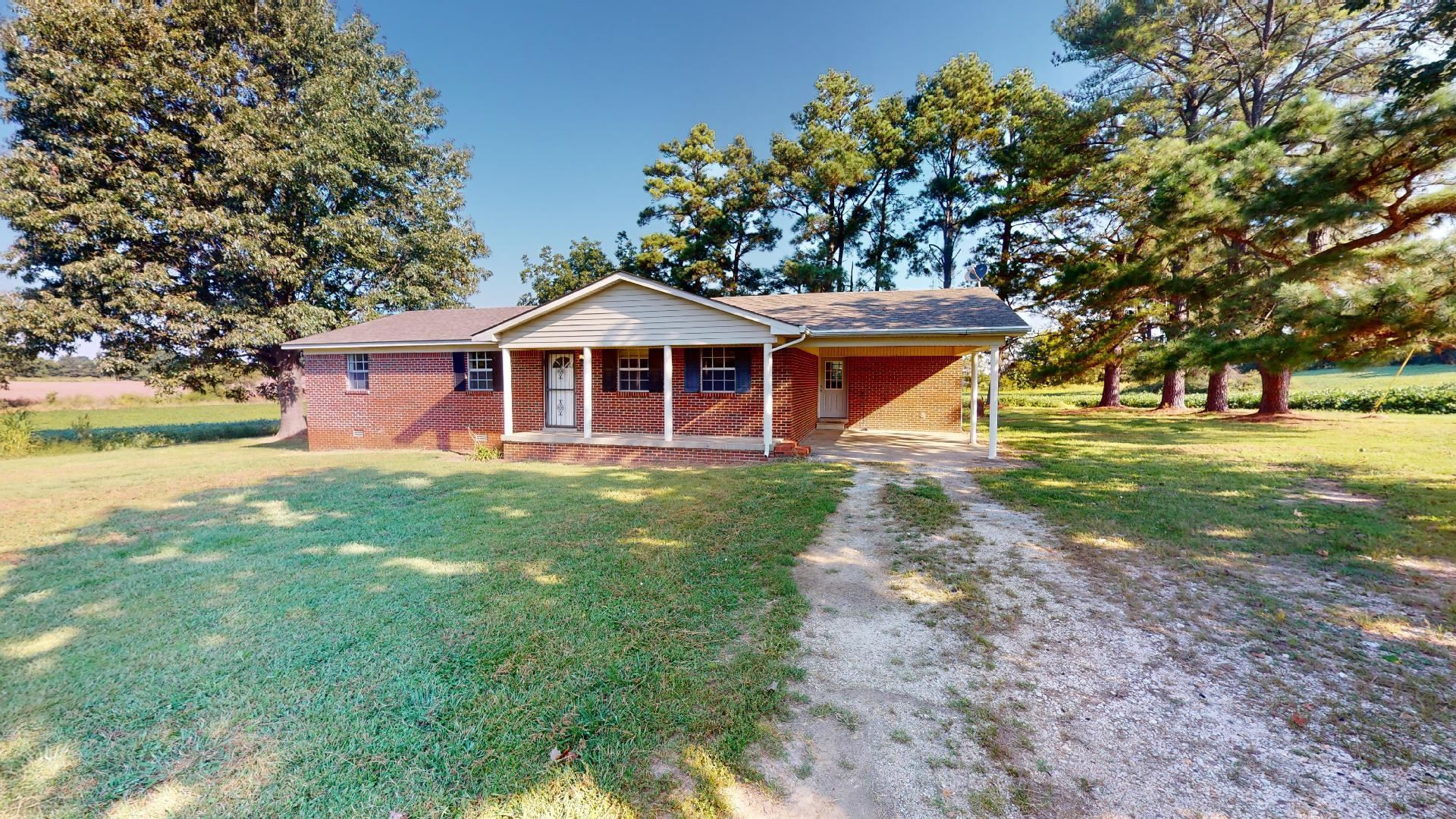 296 Enochs Road Newbern, TN 38059 - Photo 1 of 14 a front view of a house with a yard