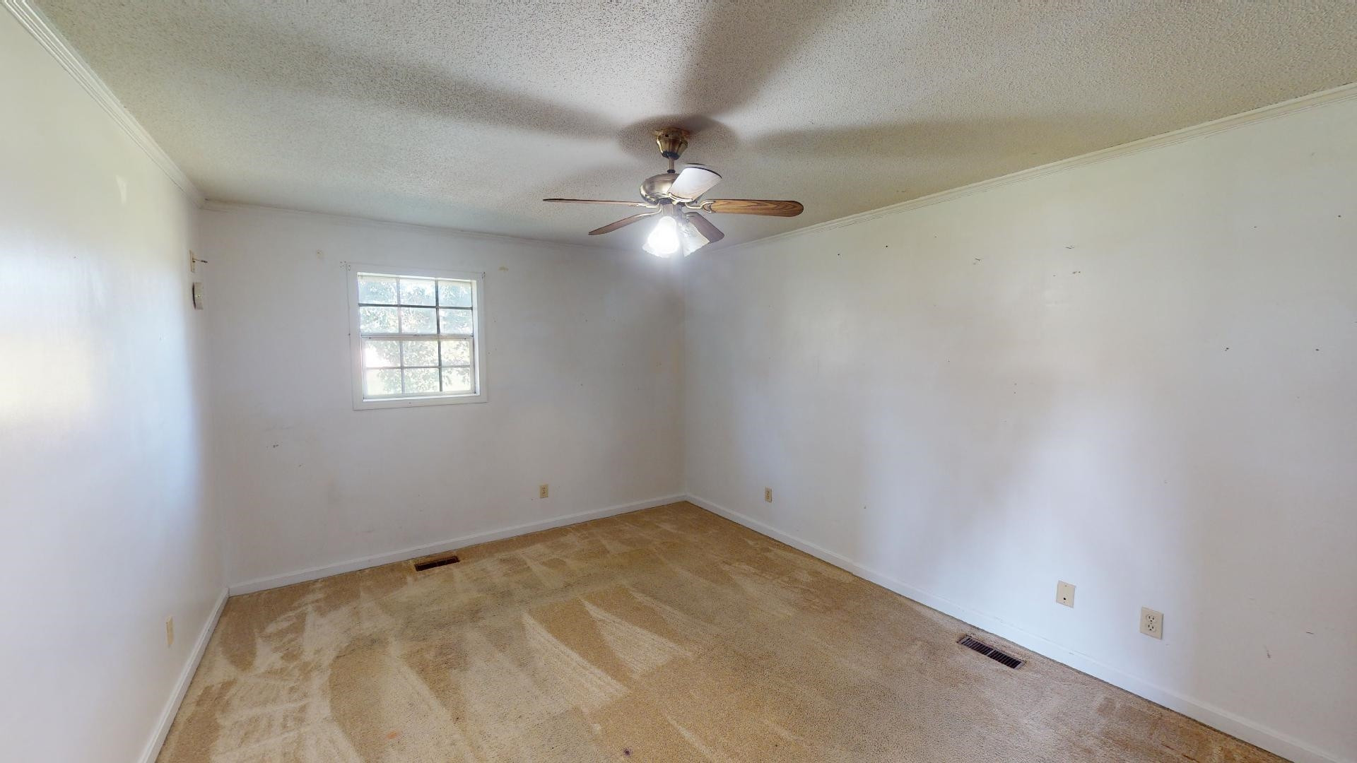 296 Enochs Road Newbern, TN 38059 - Photo 5 of 14 an empty room with windows and fan