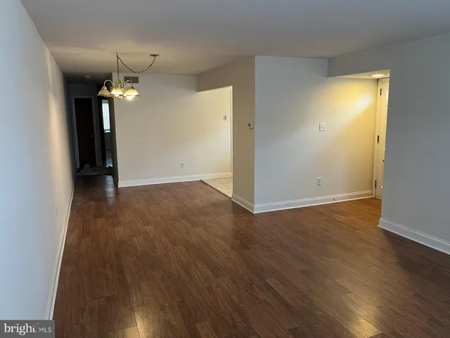 a view of hallway with wooden floor
