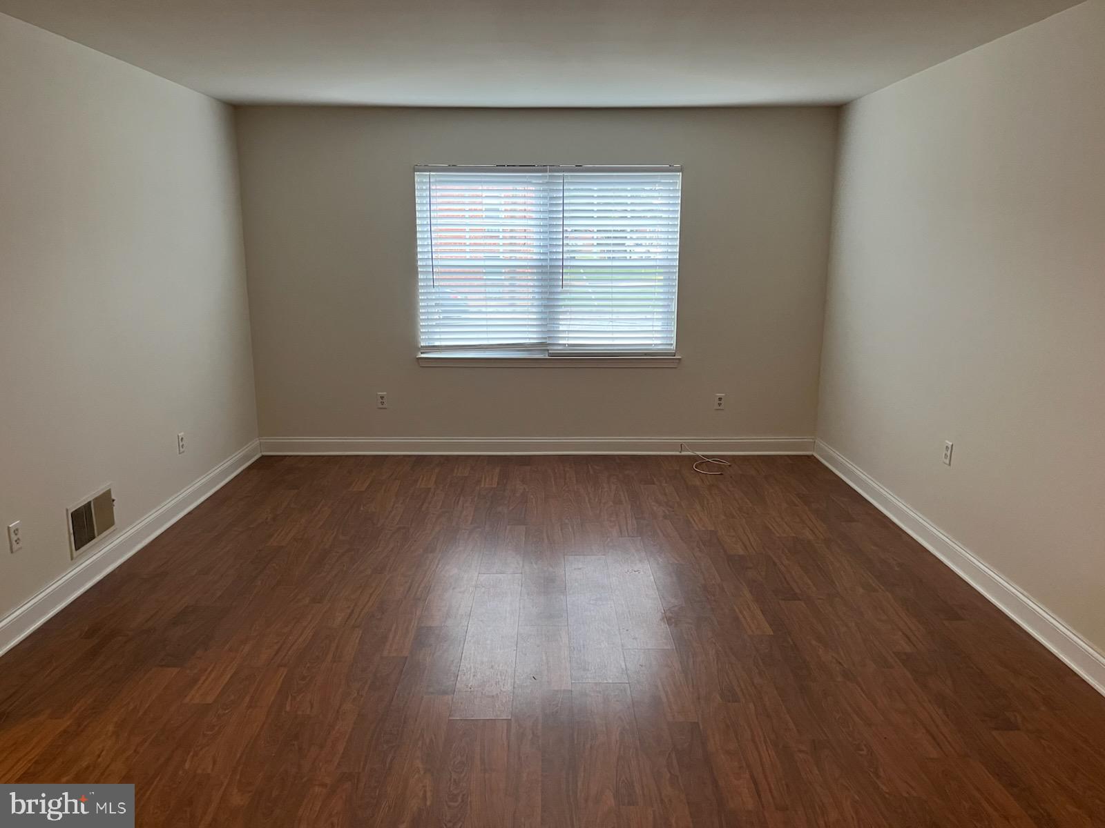 16 Apel Avenue, Unit D Oreland, PA 19075 - Photo 5 of 10 an empty room with wooden floor and windows