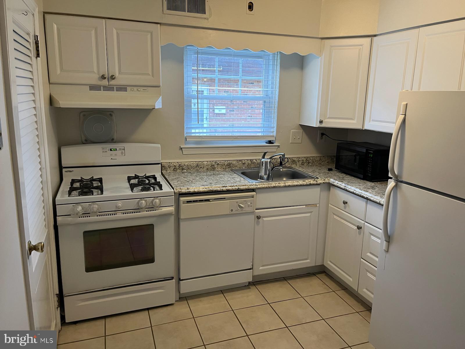 16 Apel Avenue, Unit D Oreland, PA 19075 - Photo 7 of 10 a kitchen with white cabinets and white appliances