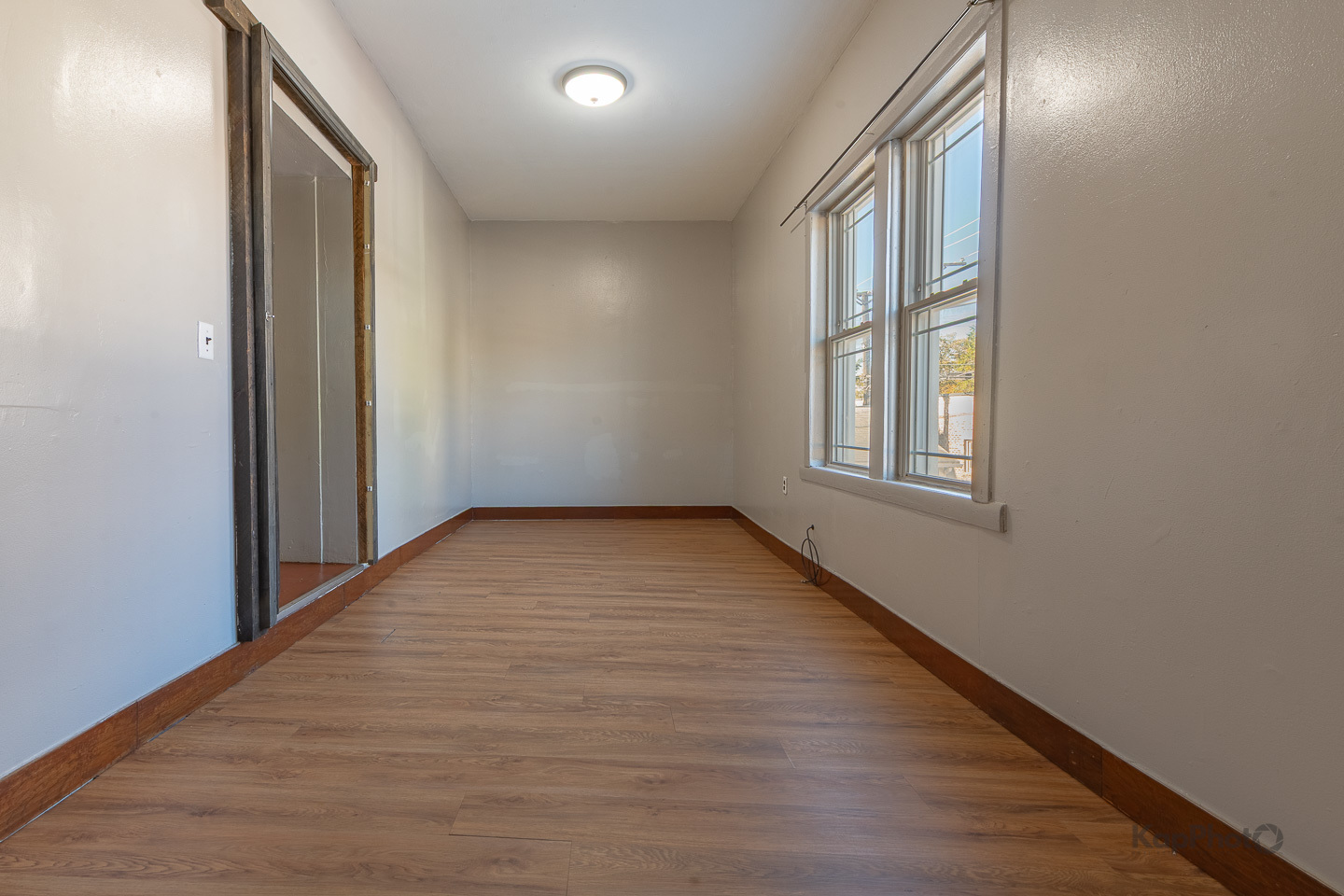 2504 South Blue Island Avenue, Unit 1R Chicago, IL 60608 - Photo 18 of 31 an empty room with wooden floor and windows