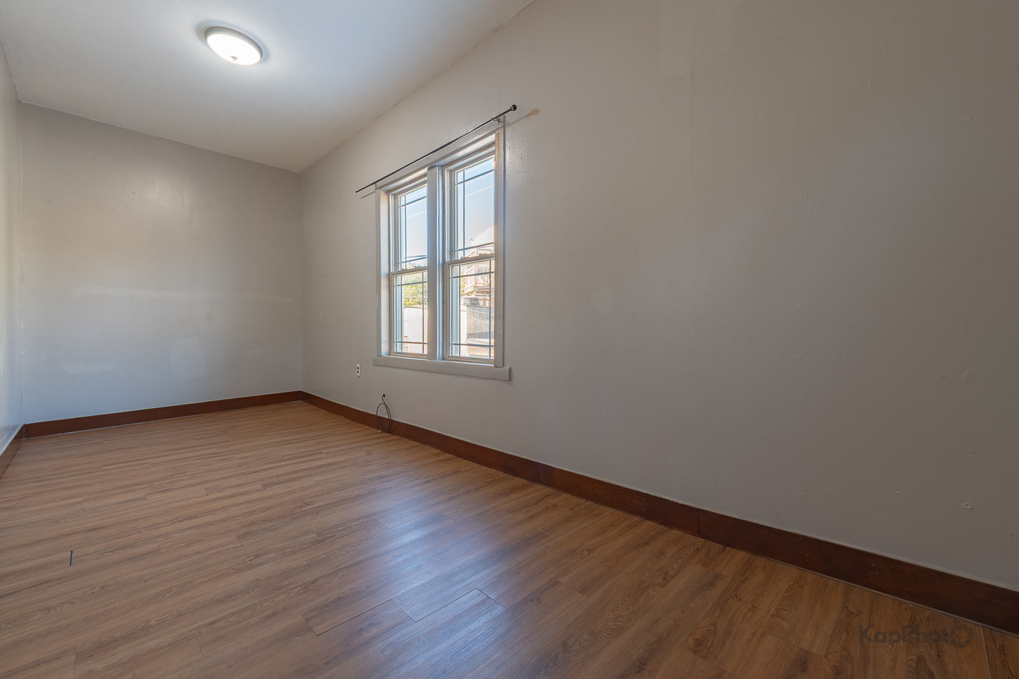 2504 South Blue Island Avenue, Unit 1R Chicago, IL 60608 - Photo 19 of 31 an empty room with wooden floor and windows