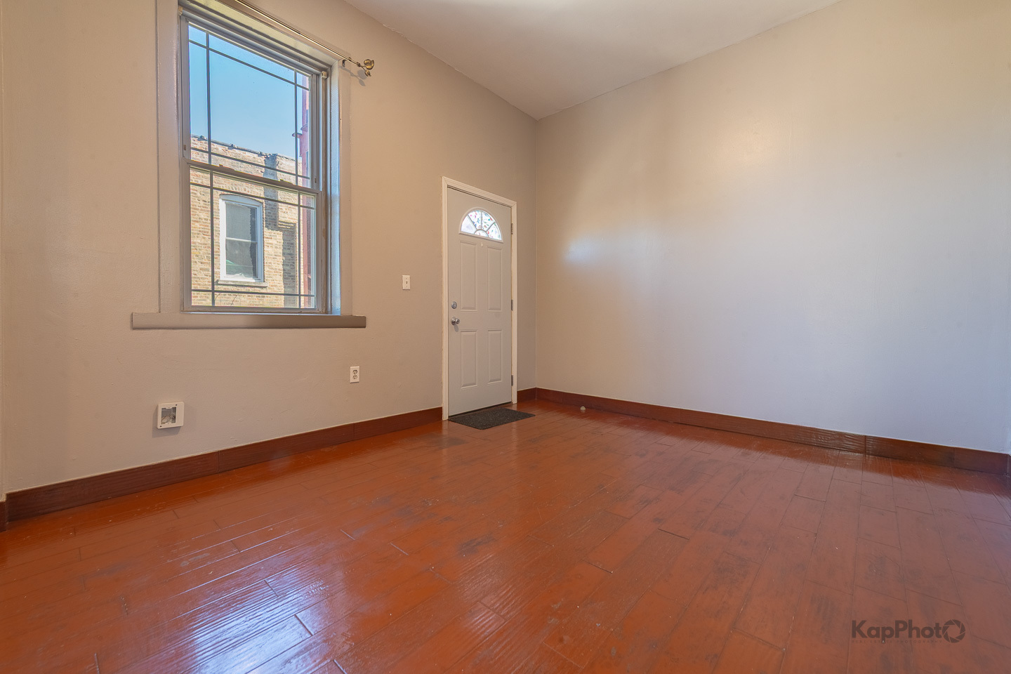 2504 South Blue Island Avenue, Unit 1R Chicago, IL 60608 - Photo 5 of 31 a view of an empty room with a window and wooden floor