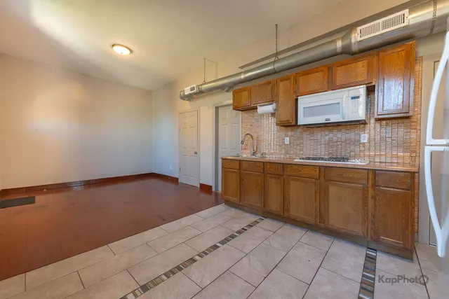a view of a kitchen with a sink and a window