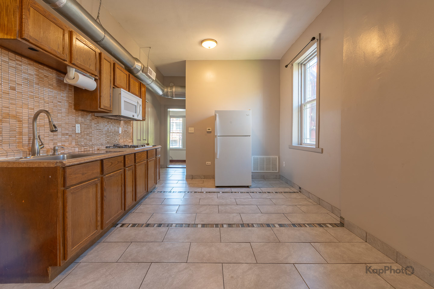 2504 South Blue Island Avenue, Unit 1R Chicago, IL 60608 - Photo 8 of 31 a view of a kitchen with a sink and a window